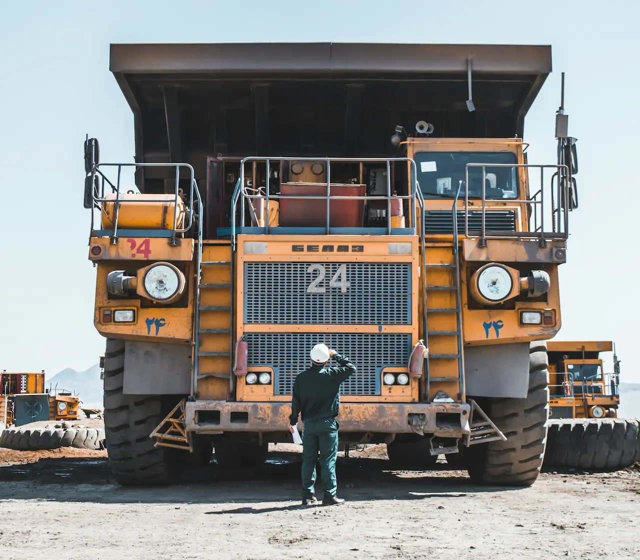 Man Standing Next To Mining Truck